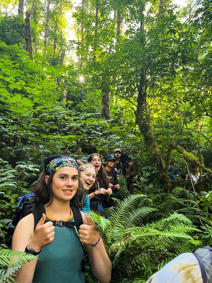 Teen campers on a trail in the forest