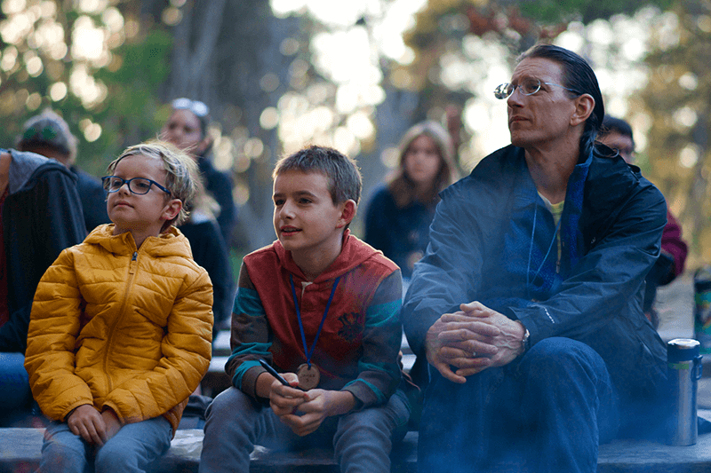 A parent and two kids at camp