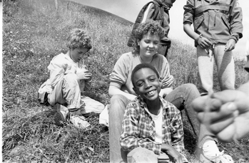 A historical photo of kids sitting in nature at camp westwind