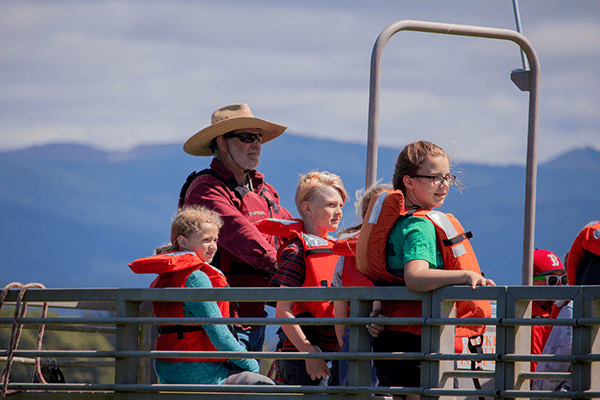 Young campers arriving at camp on a ferry with the ferry captain