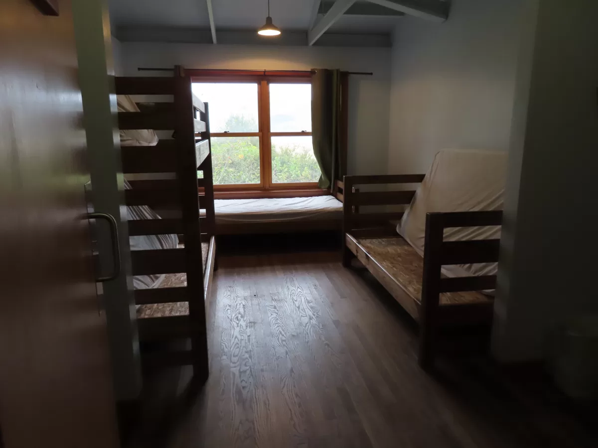 dorm room with one bunk bed and two single beds