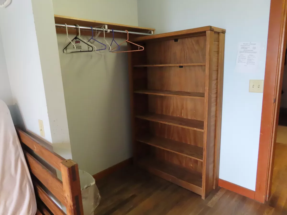 open closet with dresser and clothes bar