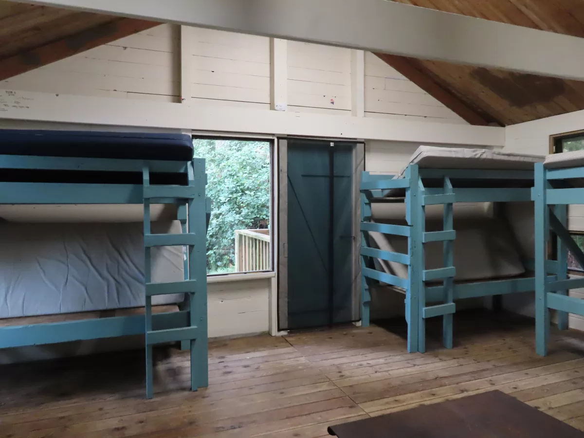 Three bunk beds against back walls.