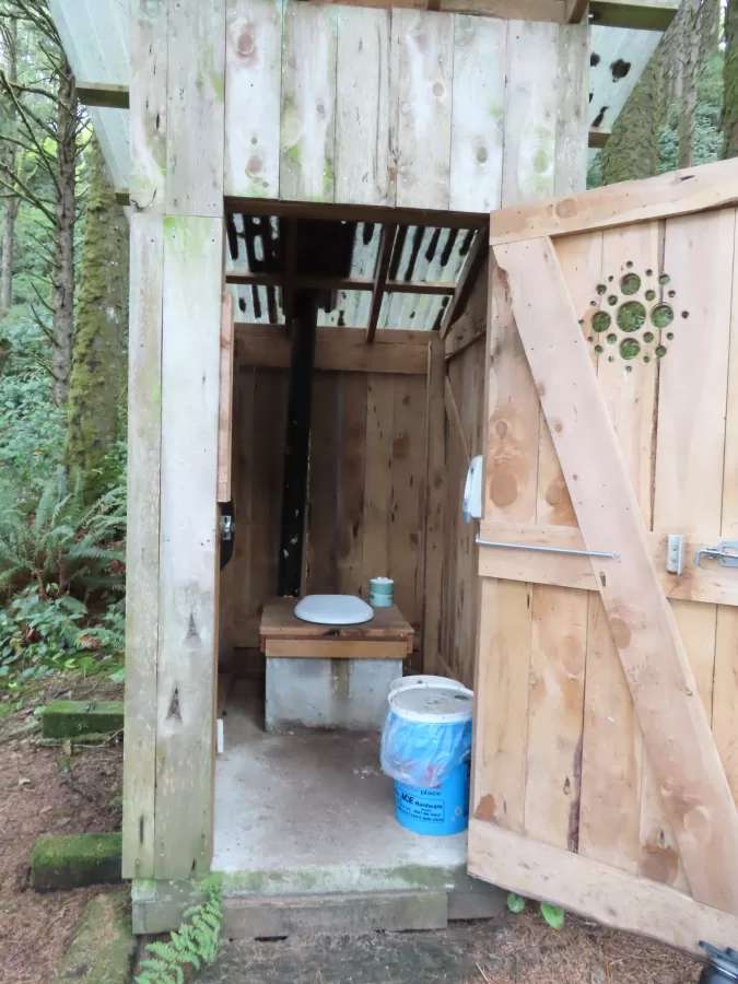 wooden outhouse with door open