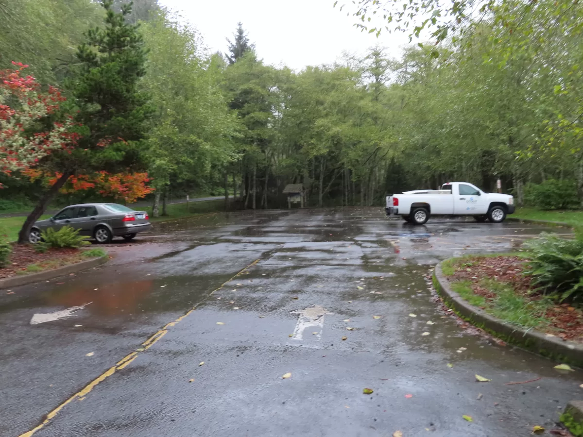 Parking lot with two parked cars.