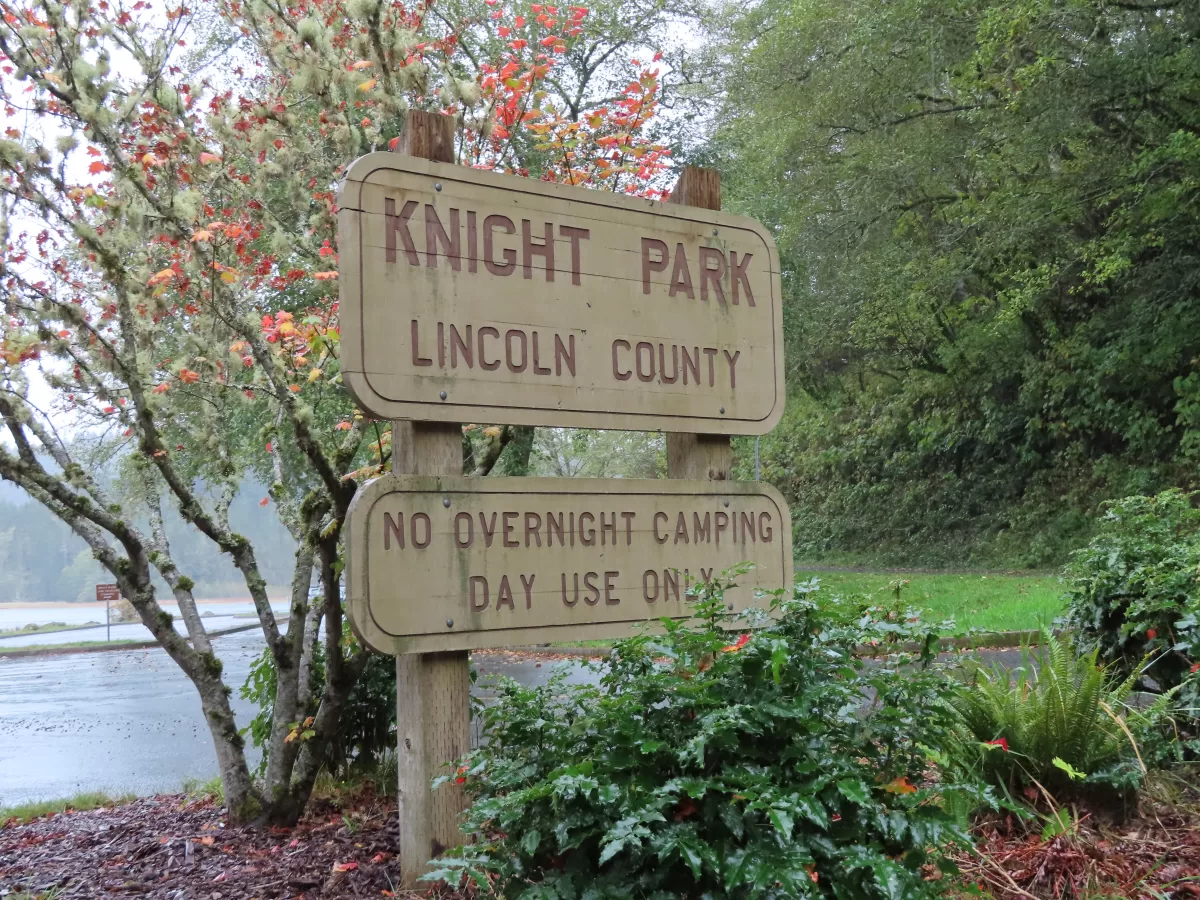 Entrance sign to parking lot. Text reads" Knight Park, Lincoln County, No overnight camping, day use only."