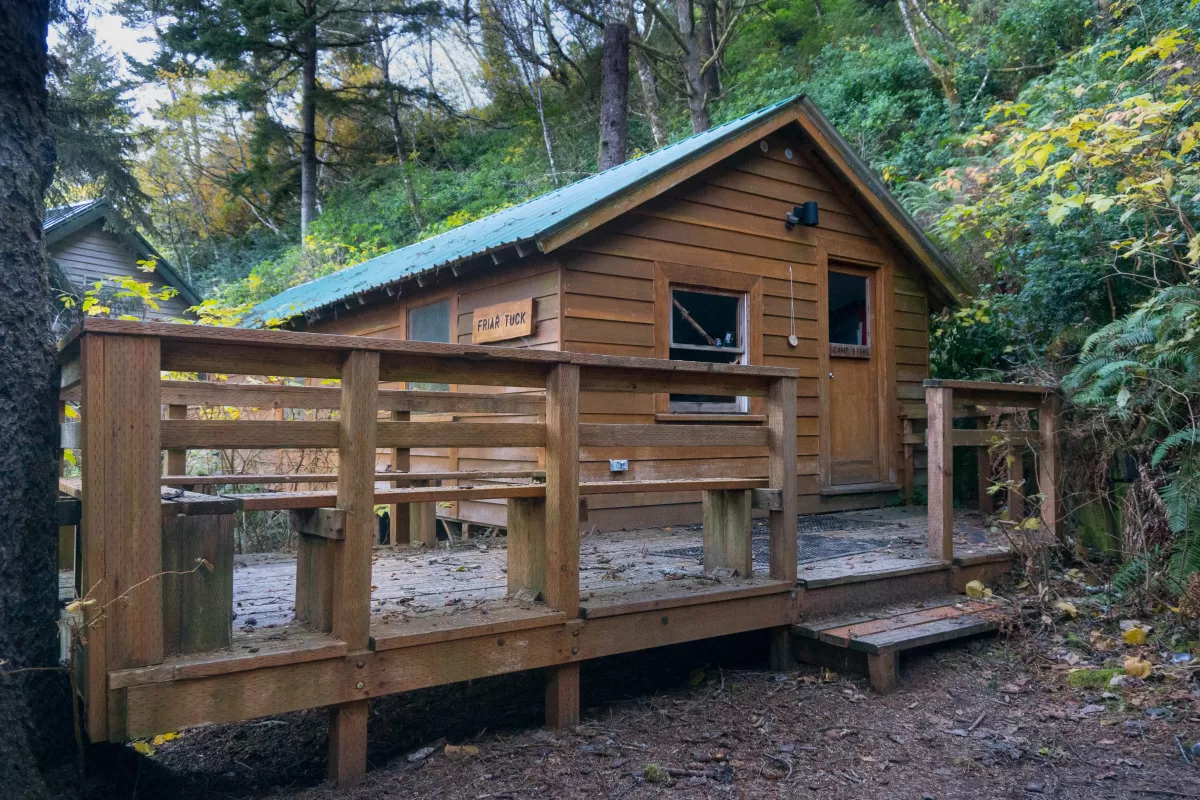 Friar Tuck front of cabin and porch