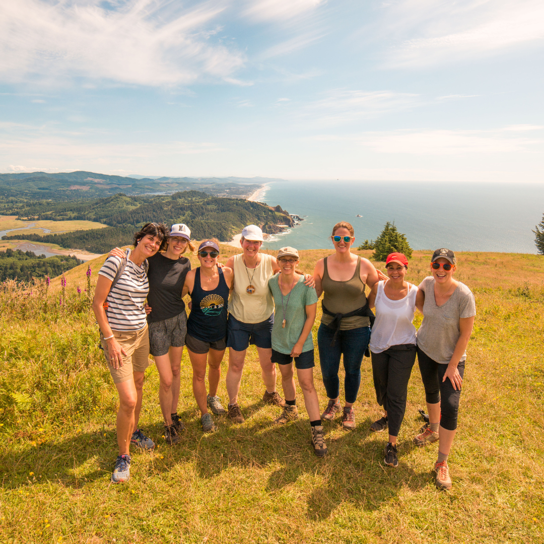 a group of woman pose for a photo on cascade head