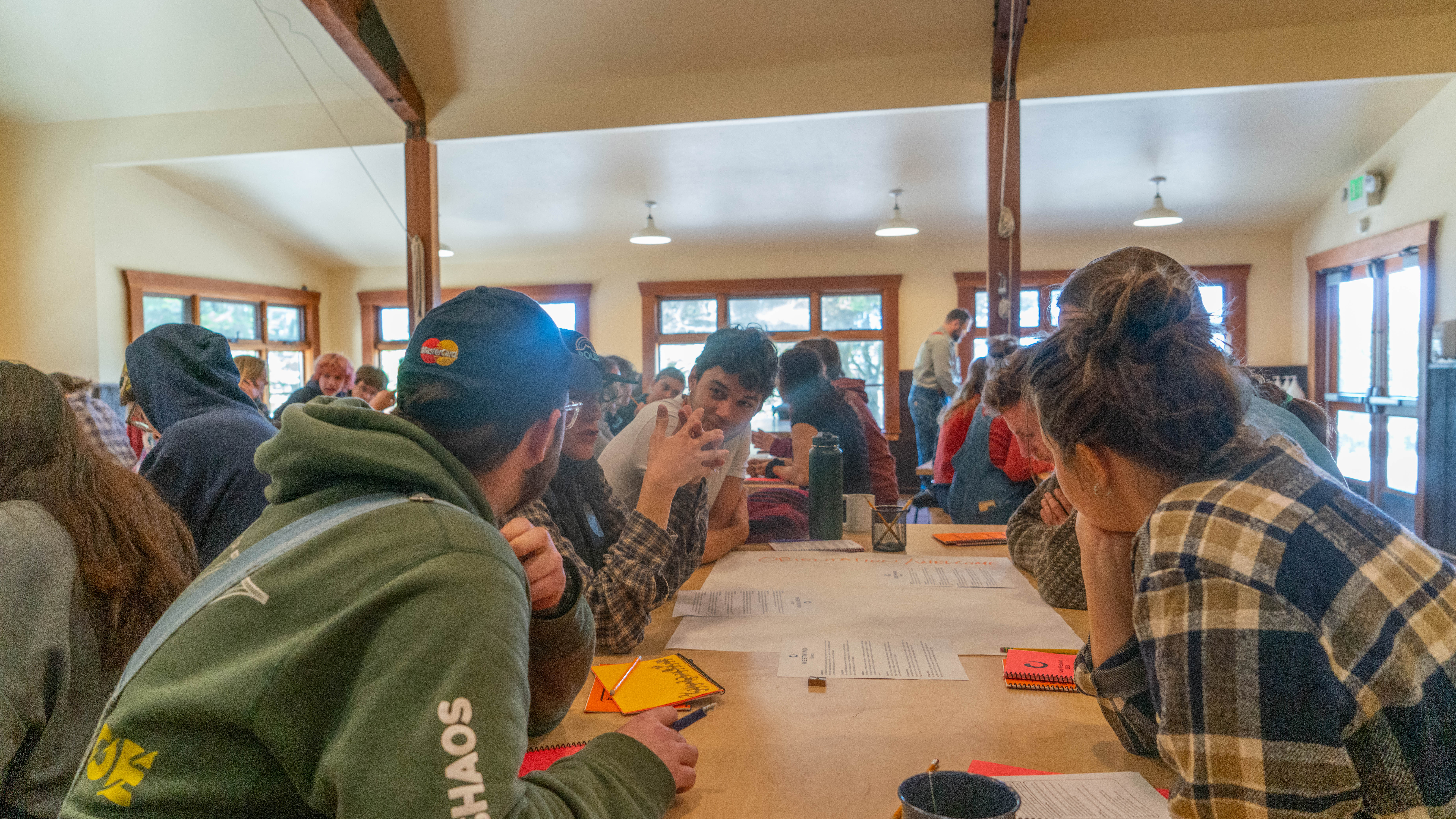 a group of staff collaborate over a wooden table