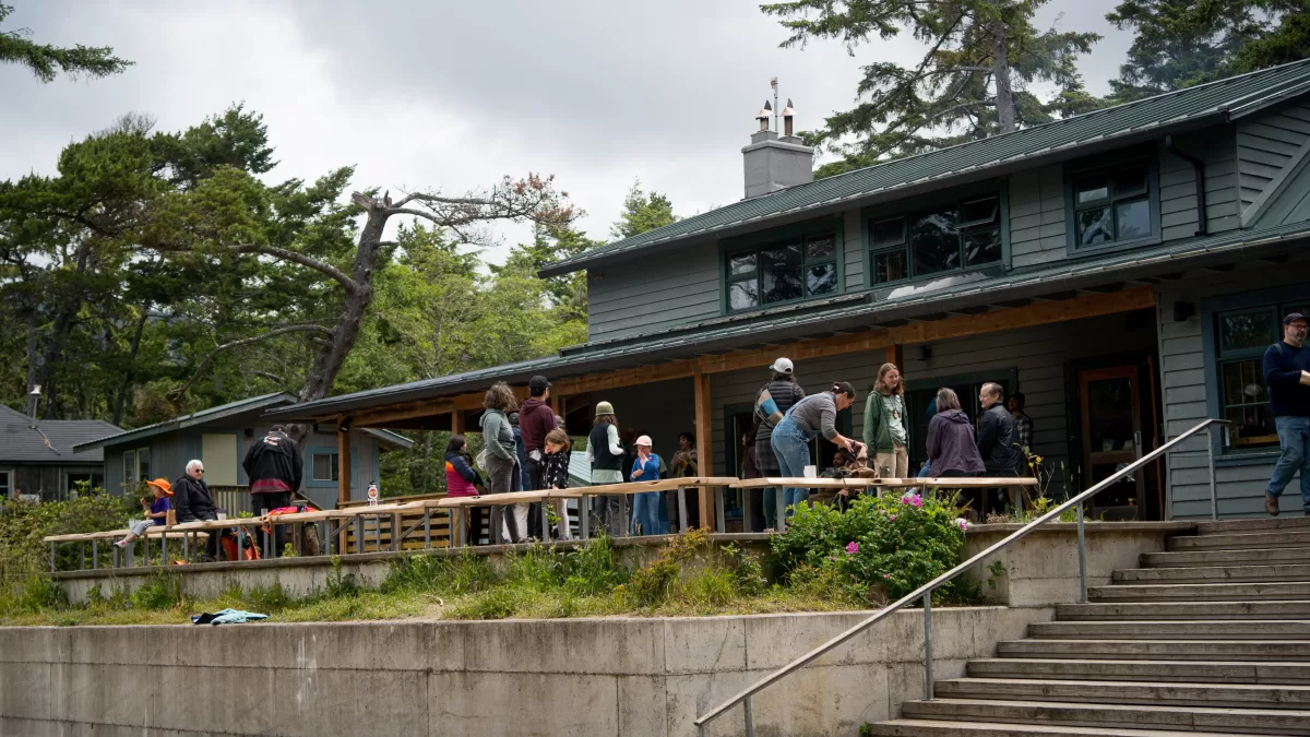 Group of people standing on the deck of the lodge.