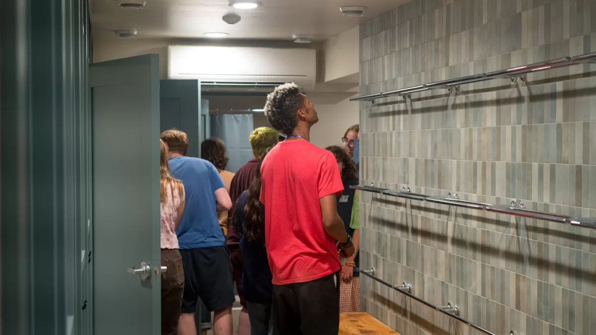 staff member examines towel racks.