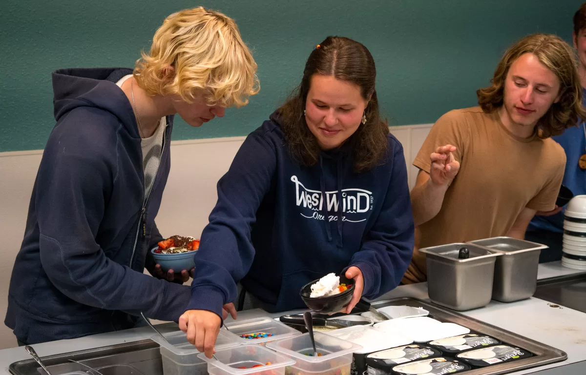 Westwind staff assemble bowls of ice cream from dessert bar