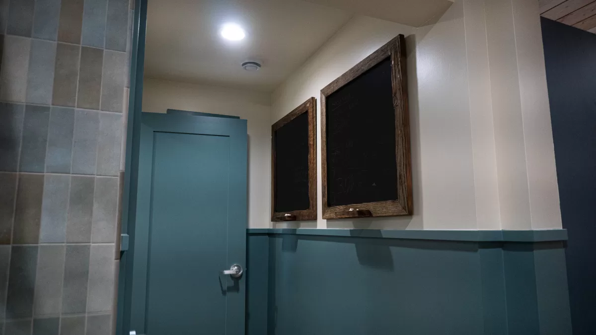 two blank blackboards hung on wall.