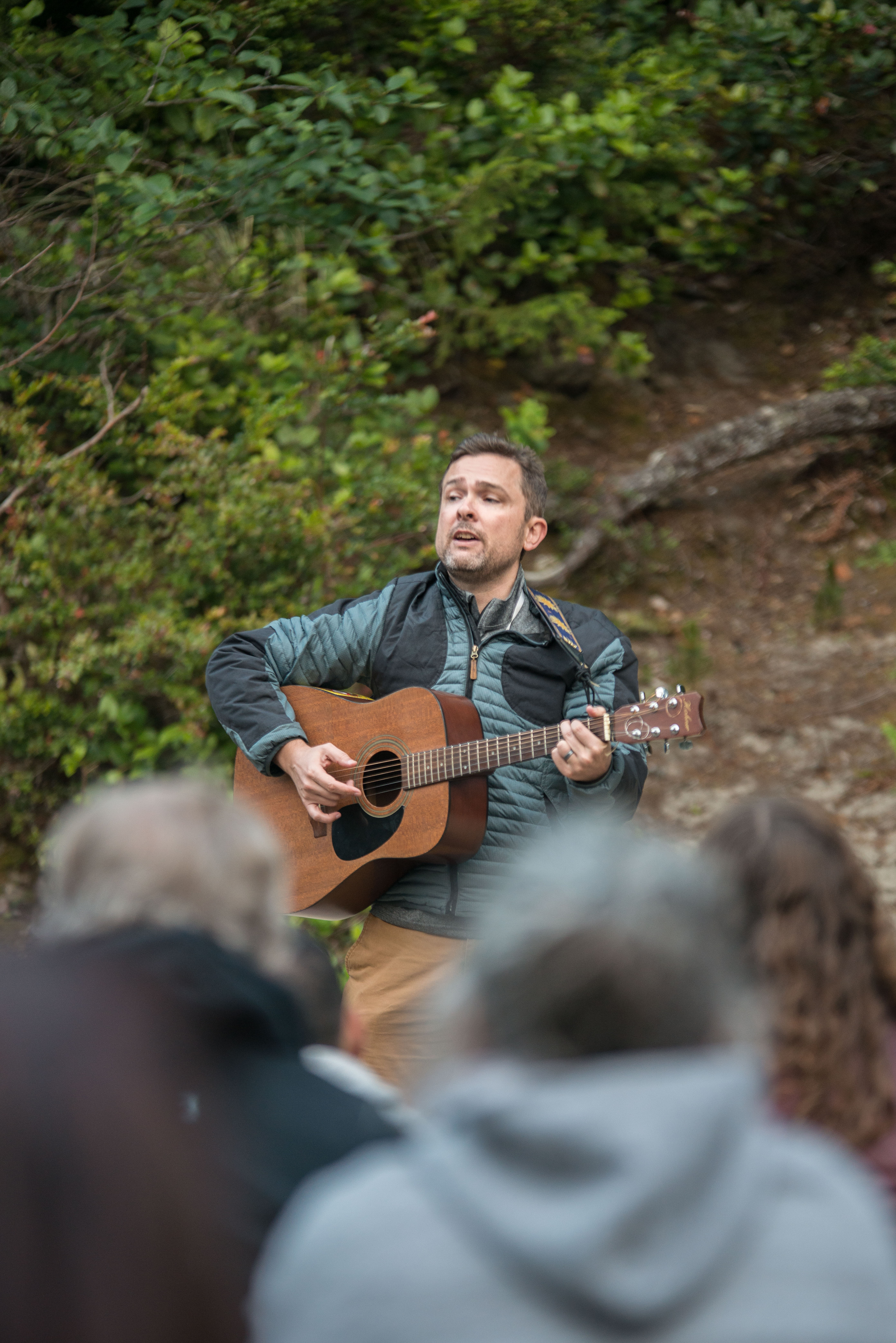 Man plays guitar for a group of people