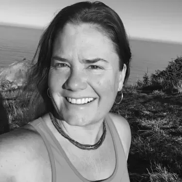 Selfie of board member Shannon Hogen standing on hill, ocean in the background.
